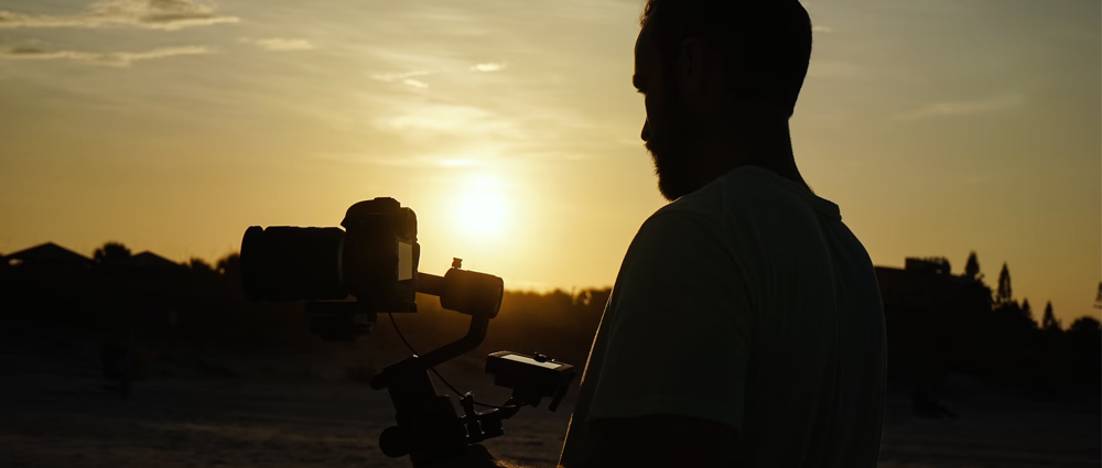 a man holding video camera depicting the trends in documentary filmmaking